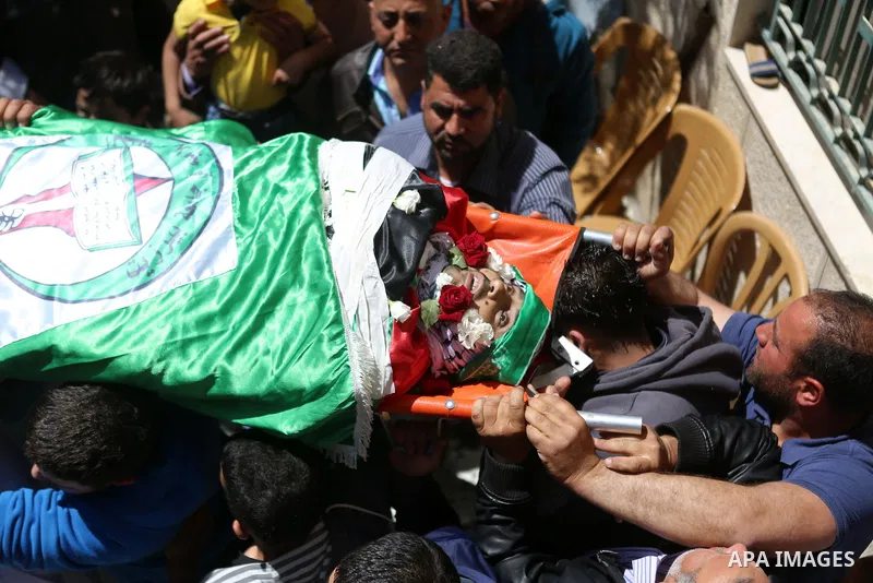 Mourners carry the body of Palestinian Ahmed Reyad Shehada, 36, whom the Israeli army said was shot dead by Israeli troops after ramming his vehicle into three Israeli soldiers, during his funeral in Bitunia near the Wes...