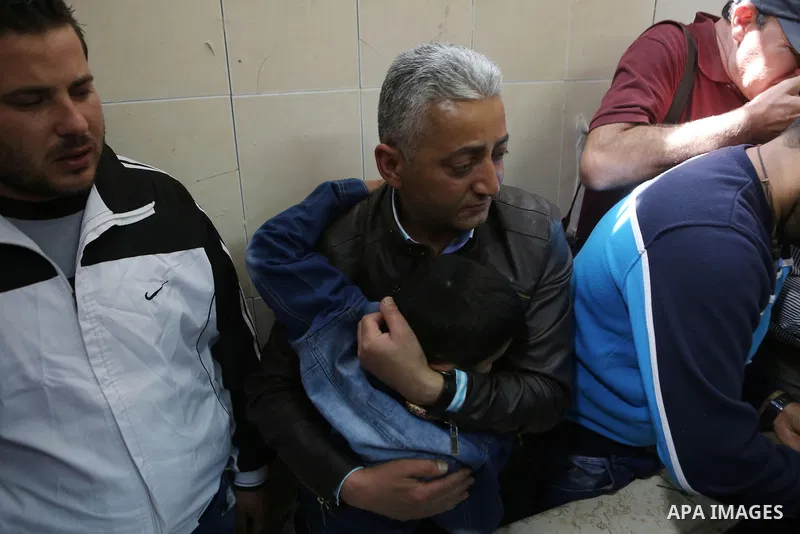 Relatives of Palestinian Ahmed Reyad Shehada, 36, whom the Israeli army said was shot dead by Israeli troops after ramming his vehicle into three Israeli soldiers, mourn during his funeral in Bitunia near the West Bank c...