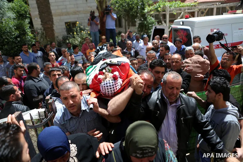 Mourners carry the body of Palestinian Ahmed Reyad Shehada, 36, whom the Israeli army said was shot dead by Israeli troops after ramming his vehicle into three Israeli soldiers, during his funeral in Bitunia near the Wes...