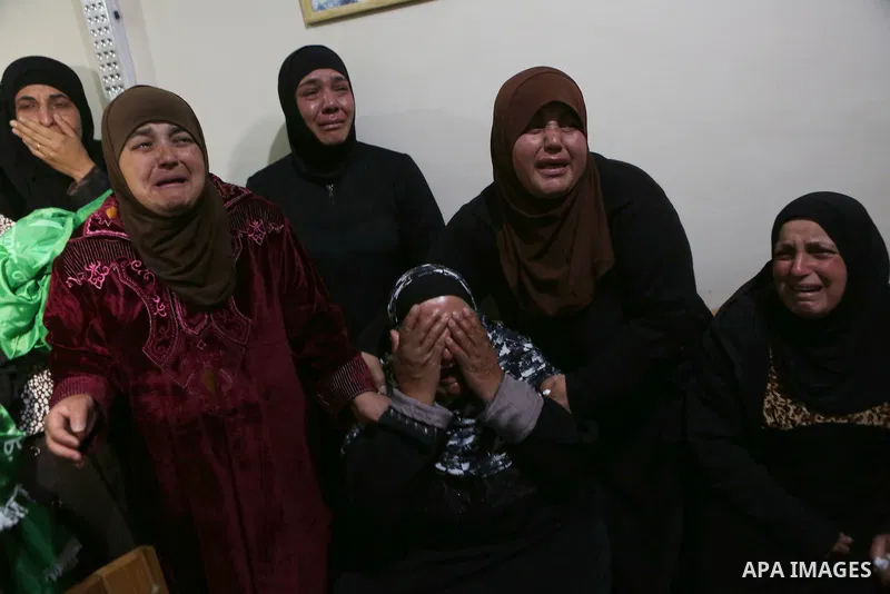 Relatives of Palestinian Ahmed Reyad Shehada, 36, whom the Israeli army said was shot dead by Israeli troops after ramming his vehicle into three Israeli soldiers, mourn during his funeral in Bitunia near the West Bank c...