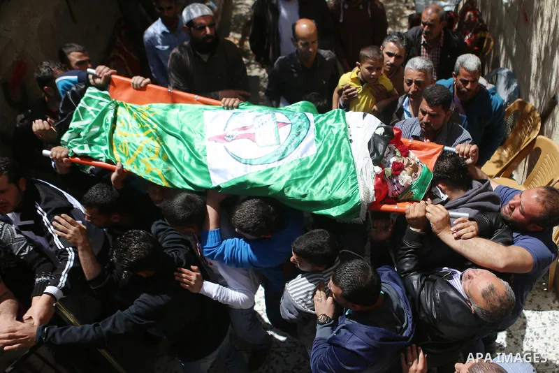 Mourners carry the body of Palestinian Ahmed Reyad Shehada, 36, whom the Israeli army said was shot dead by Israeli troops after ramming his vehicle into three Israeli soldiers, during his funeral in Bitunia near the Wes...