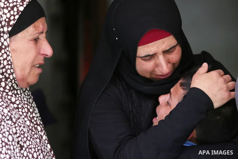 Relatives of Palestinian Ahmed Reyad Shehada, 36, whom the Israeli army said was shot dead by Israeli troops after ramming his vehicle into three Israeli soldiers, mourn during his funeral in Bitunia near the West Bank c...