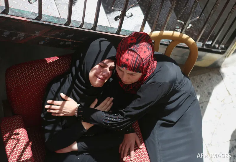Relatives of Palestinian Ahmed Reyad Shehada, 36, whom the Israeli army said was shot dead by Israeli troops after ramming his vehicle into three Israeli soldiers, mourn during his funeral in Bitunia near the West Bank c...