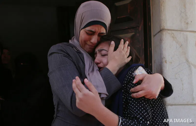 Relatives of Palestinian Ahmed Reyad Shehada, 36, whom the Israeli army said was shot dead by Israeli troops after ramming his vehicle into three Israeli soldiers, mourn during his funeral in Bitunia near the West Bank c...