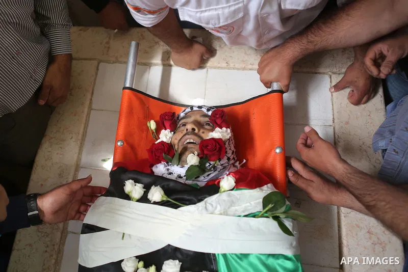Relatives of Palestinian Ahmed Reyad Shehada, 36, whom the Israeli army said was shot dead by Israeli troops after ramming his vehicle into three Israeli soldiers, mourn during his funeral in Bitunia near the West Bank c...