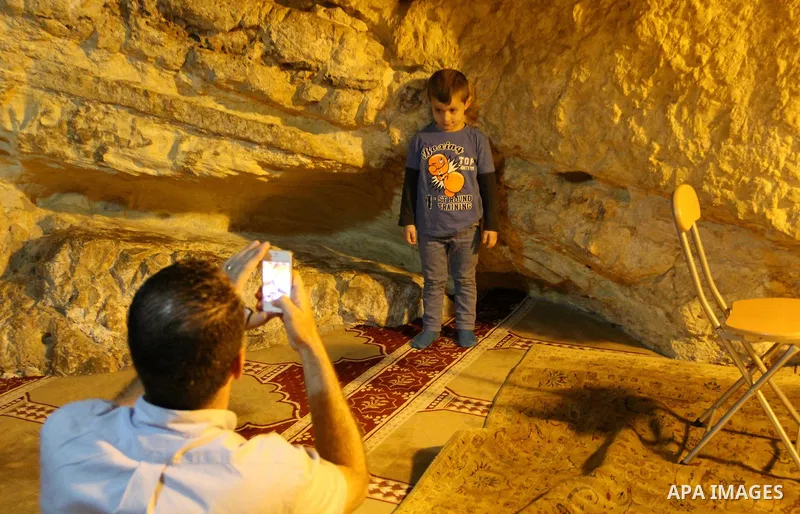 A Palestinian man takes a selfie for his son inside Al-Aqsa mosque compound in Jerusalem's Old city on May 4, 2016. Photo by Mahfouz Abu Turk