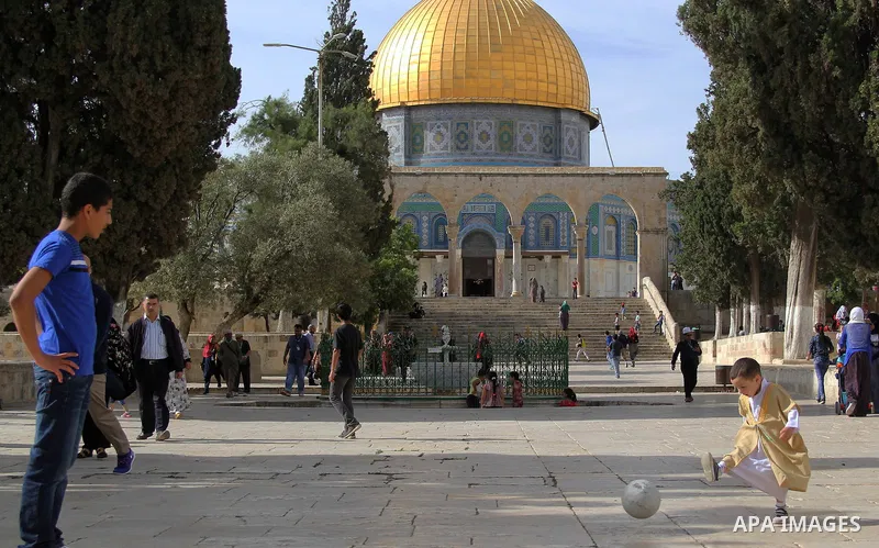 Palestinian boys play football in front of Dome of the Rock mosque at the Al-Aqsa mosque compound in Jerusalem's Old city on May 4, 2016. Photo by Mahfouz Abu Turk