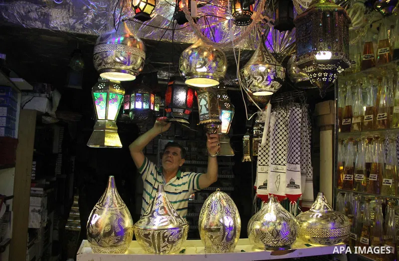 A Palestinian vendor displays goods at market in Jerusalem's old city on May 4, 2016. Photo by Mahfouz Abu Turk
