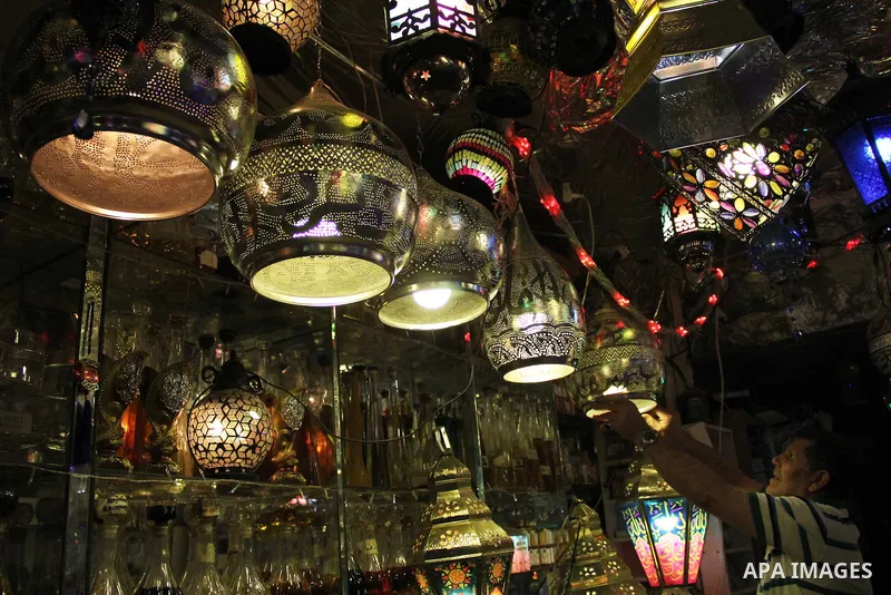 A Palestinian vendor displays goods at market in Jerusalem's old city on May 4, 2016. Photo by Mahfouz Abu Turk