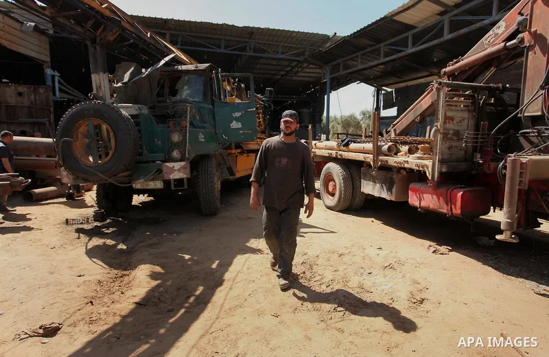A Palestinian man inspects the scene of what witnesses said was an air strike on a workshop in Gaza City, in the early hours of May 5, 2016. Israeli air strikes hit four Hamas sites in Gaza overnight, the military said,...