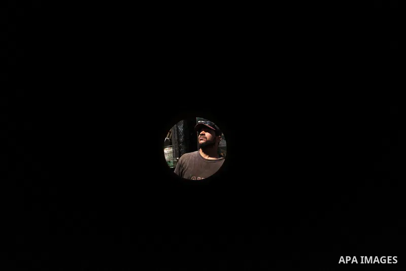 A Palestinian man inspects the scene of what witnesses said was an air strike on a workshop in Gaza City, in the early hours of May 5, 2016. Israeli air strikes hit four Hamas sites in Gaza overnight, the military said,...
