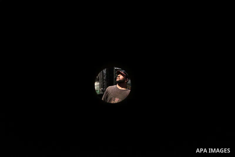 A Palestinian man inspects the scene of what witnesses said was an air strike on a workshop in Gaza City, in the early hours of May 5, 2016. Israeli air strikes hit four Hamas sites in Gaza overnight, the military said,...