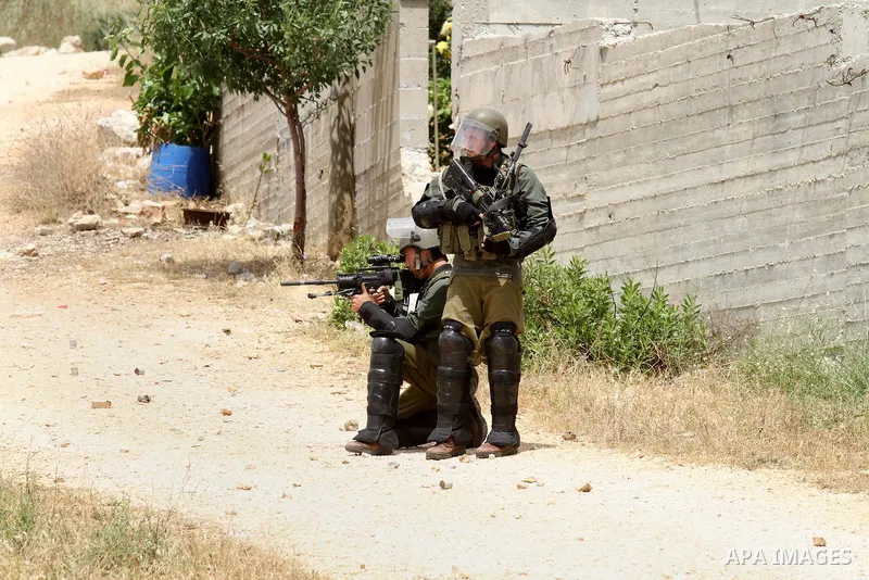 Israeli security forces aim at Palestinian protesters during clashes following a demonstration against the expropriation of Palestinian land by Israel on May 06, 2016 in the village of Kfar Qaddum, near Nablus, in the oc...