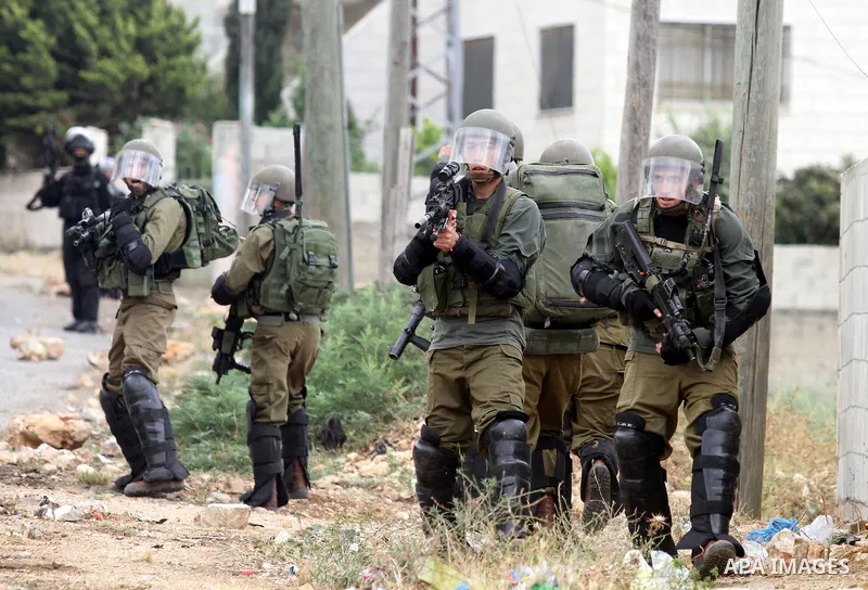 Israeli security forces aim at Palestinian protesters during clashes following a demonstration against the expropriation of Palestinian land by Israel on May 06, 2016 in the village of Kfar Qaddum, near Nablus, in the oc...