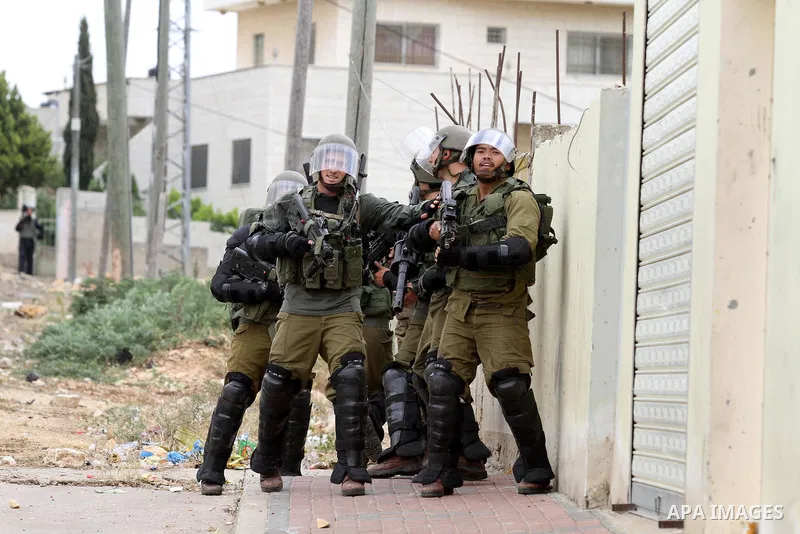 Israeli security forces aim at Palestinian protesters during clashes following a demonstration against the expropriation of Palestinian land by Israel on May 06, 2016 in the village of Kfar Qaddum, near Nablus, in the oc...