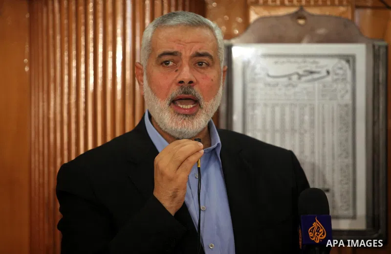 Palestinian Islamist movement Hamas' chief, Ismail Haniya gives a speech at a mosque during the funeral of three children from the al-Hindi family, who died in a fire caused by a candle at the family home at the al-Shati...