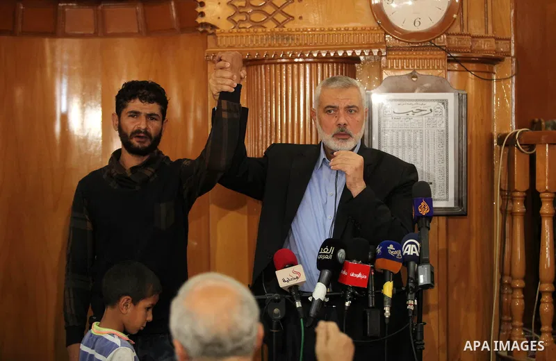 Palestinian Islamist movement Hamas' chief, Ismail Haniya gives a speech at a mosque during the funeral of three children from the al-Hindi family, who died in a fire caused by a candle at the family home at the al-Shati...