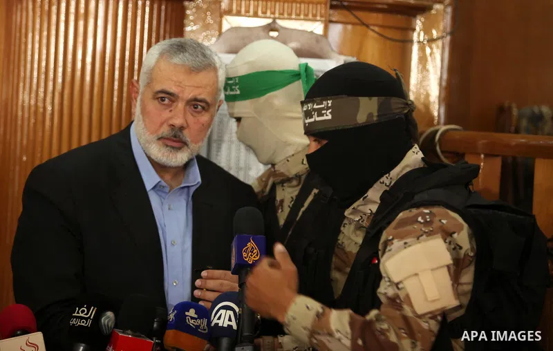 Palestinian Islamist movement Hamas' chief, Ismail Haniya gives a speech at a mosque during the funeral of three children from the al-Hindi family, who died in a fire caused by a candle at the family home at the al-Shati...