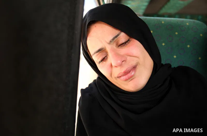 The mother of the al-Hindi family mourns during the funeral of three of her sons who died in a fire caused by a candle at the family home, at the al-Shati refugee camp in Gaza City on May 7, 2016. Photo by Ashraf Amra