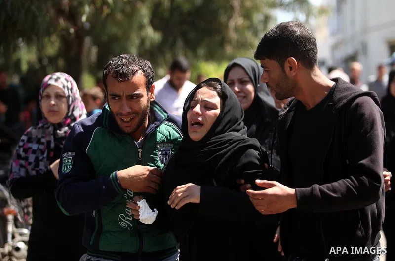 The mother of the al-Hindi family mourns during the funeral of three of her sons who died in a fire caused by a candle at the family home, at the al-Shati refugee camp in Gaza City on May 7, 2016. Photo by Ashraf Amra