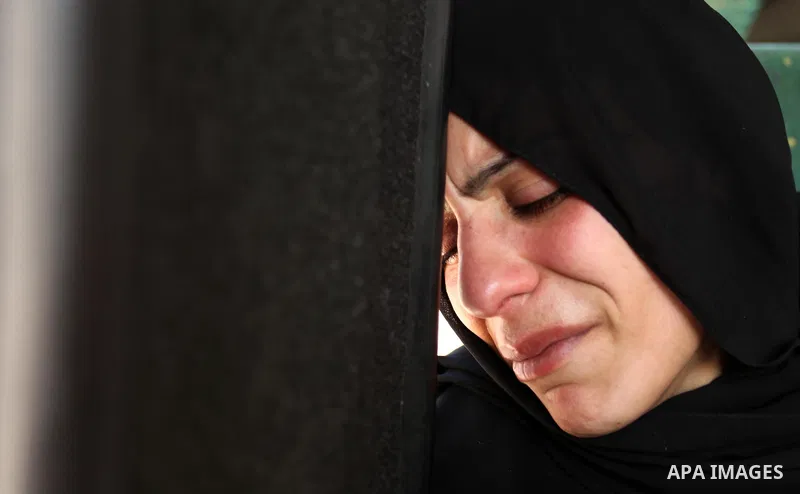 The mother of the al-Hindi family mourns during the funeral of three of her sons who died in a fire caused by a candle at the family home, at the al-Shati refugee camp in Gaza City on May 7, 2016. Photo by Ashraf Amra