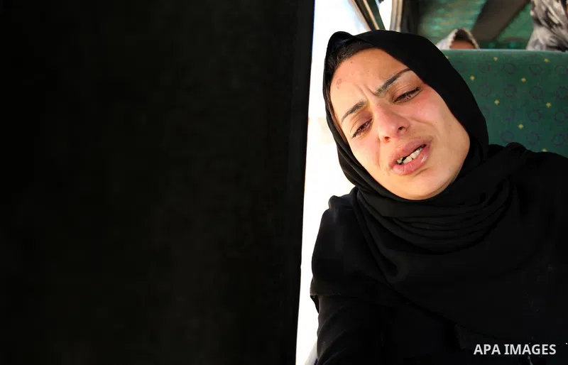 The mother of the al-Hindi family mourns during the funeral of three of her sons who died in a fire caused by a candle at the family home, at the al-Shati refugee camp in Gaza City on May 7, 2016. Photo by Ashraf Amra