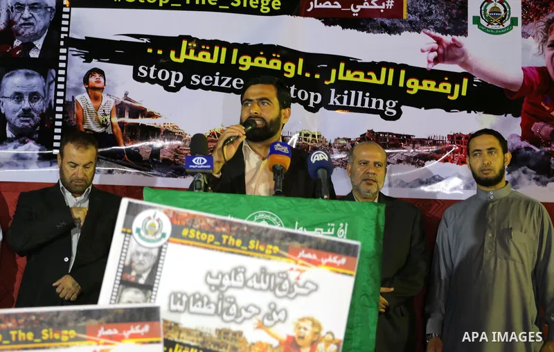 Mushir Al Masri, a Hamas MP and media spokesman speaks during a protest demanding for end the siege on Gaza and against the killing of three boys from the al-Hindi family, who died in a fire caused by a candle at the fam...