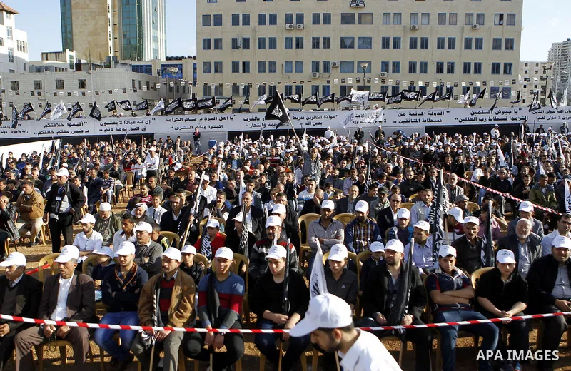 Palestinian supporters of the Islamist party Hizb Ut-Tahrir take part in a rally to mark the 95th anniversary of the overthrow of the Islamic Caliphate, in the West Bank city of Hebron on May 7, 2016. Photo by Wisam Hash...