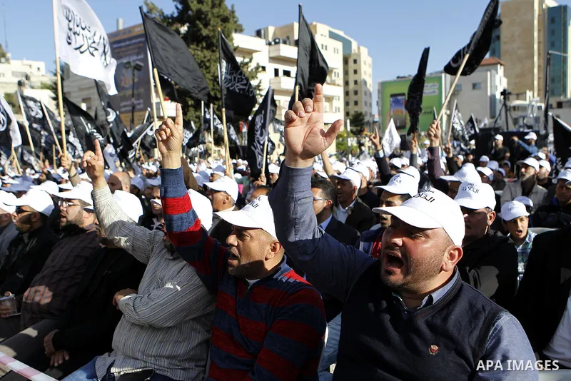 Palestinian supporters of the Islamist party Hizb Ut-Tahrir take part in a rally to mark the 95th anniversary of the overthrow of the Islamic Caliphate, in the West Bank city of Hebron on May 7, 2016. Photo by Wisam Hash...