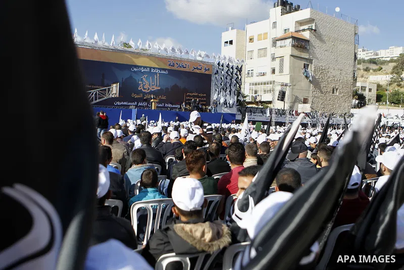 Palestinian supporters of the Islamist party Hizb Ut-Tahrir take part in a rally to mark the 95th anniversary of the overthrow of the Islamic Caliphate, in the West Bank city of Hebron on May 7, 2016. Photo by Wisam Hash...