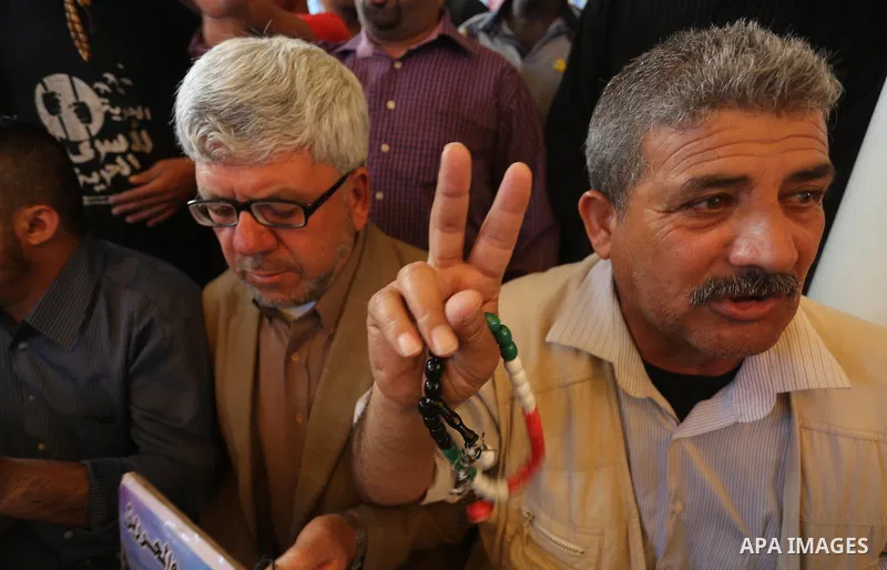 Palestinians take part in a protest demanding release the prisoners in Israeli jails, in front of Red cross office, in Gaza city, on May 9, 2016. Photo by Mohammed Asad
