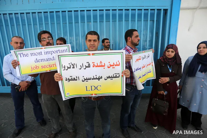 Palestinian engineers hold banners during a protest against the UNRWA decision to reduce of the work contracts in front of the headquarters United Nations Relief and Works Agency (UNRWA) in Gaza city, on May 9, 2016. Pho...