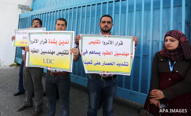 Palestinian engineers hold banners during a protest against the UNRWA decision to reduce of the work contracts in front of the headquarters United Nations Relief and Works Agency (UNRWA) in Gaza city, on May 9, 2016. Pho...