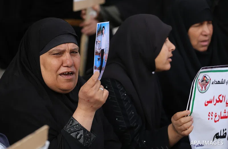 Palestinian families of martyrs, hold banners during a protest to demand their salaries, in Gaza city, on May 10, 2016. Photo by Mohammed Asad