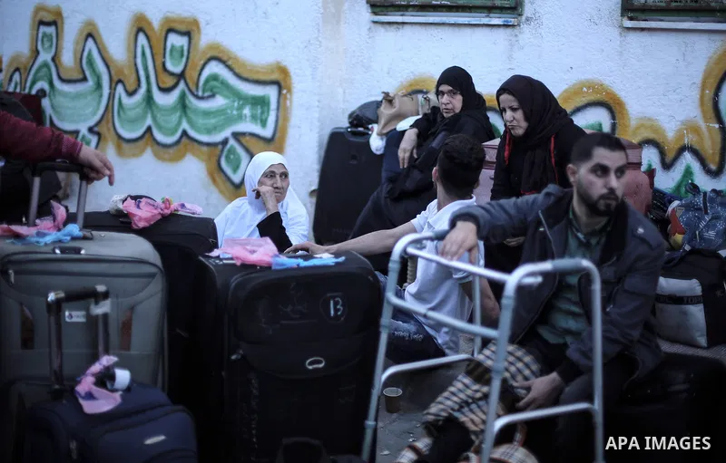 Palestinians wait for travel permits to cross into Egypt through the Rafah border crossing after it was opened for two days by Egyptian authorities, in the southern Gaza Strip May 11, 2016. Photo by Mohammed Dahman