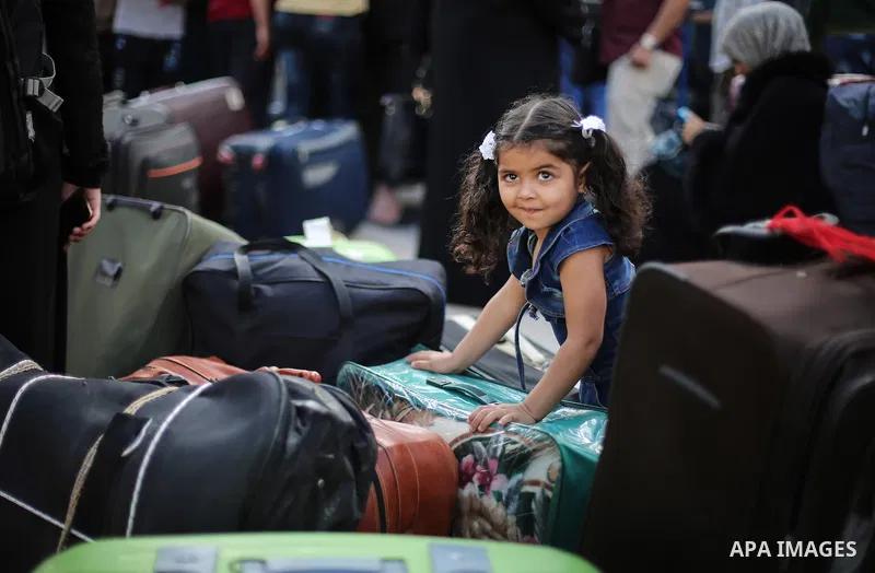 Palestinians wait for travel permits to cross into Egypt through the Rafah border crossing after it was opened for two days by Egyptian authorities, in the southern Gaza Strip May 11, 2016. Photo by Mohammed Dahman