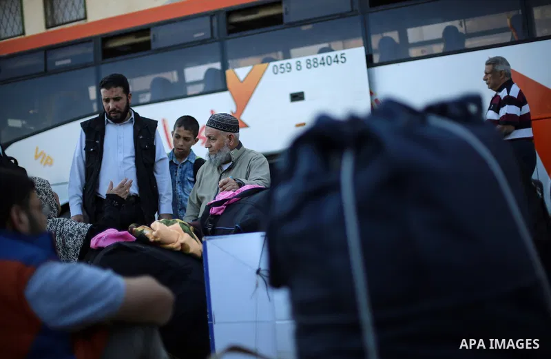 Palestinians wait for travel permits to cross into Egypt through the Rafah border crossing after it was opened for two days by Egyptian authorities, in the southern Gaza Strip May 11, 2016. Photo by Mohammed Dahman