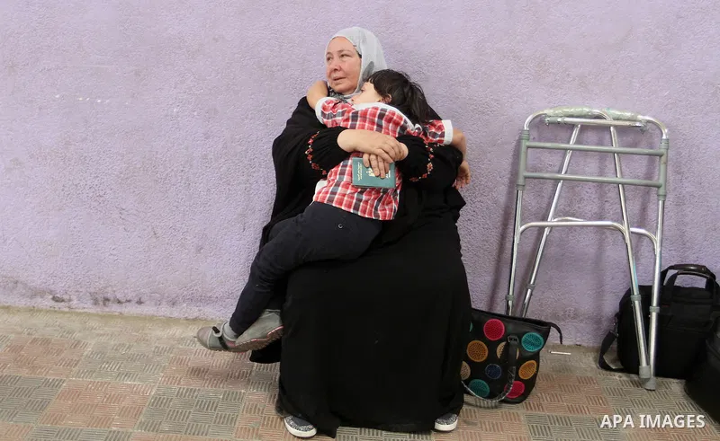 A Palestinian woman waits at the Rafah border crossing with Egypt, in the southern Gaza Strip, after it was opened for two days by Egyptian authorities, on May 11, 2016. On May 2 Israeli Defence Minister Moshe Yaalon on...