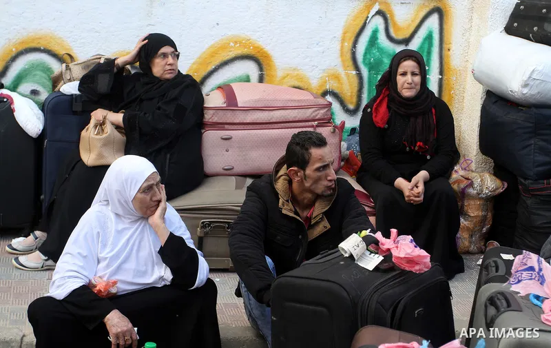 Palestinians wait at the Rafah border crossing with Egypt, in the southern Gaza Strip, after it was opened for two days by Egyptian authorities, on May 11, 2016. On May 2 Israeli Defence Minister Moshe Yaalon on Monday a...