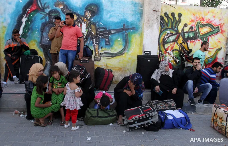 Palestinians wait at the Rafah border crossing with Egypt, in the southern Gaza Strip, after it was opened for two days by Egyptian authorities, on May 11, 2016. On May 2 Israeli Defence Minister Moshe Yaalon on Monday a...