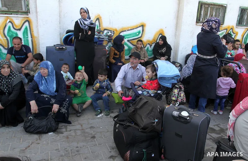 Palestinians wait at the Rafah border crossing with Egypt, in the southern Gaza Strip, after it was opened for two days by Egyptian authorities on May 12, 2016. Israeli Defence Minister Moshe Yaalon announced on May 2, 2...