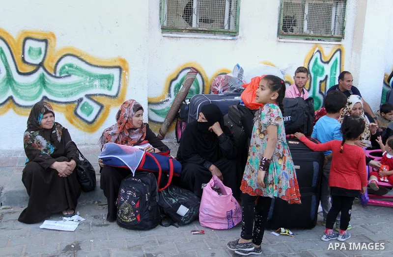 Palestinians wait at the Rafah border crossing with Egypt, in the southern Gaza Strip, after it was opened for two days by Egyptian authorities on May 12, 2016. Israeli Defence Minister Moshe Yaalon announced on May 2, 2...