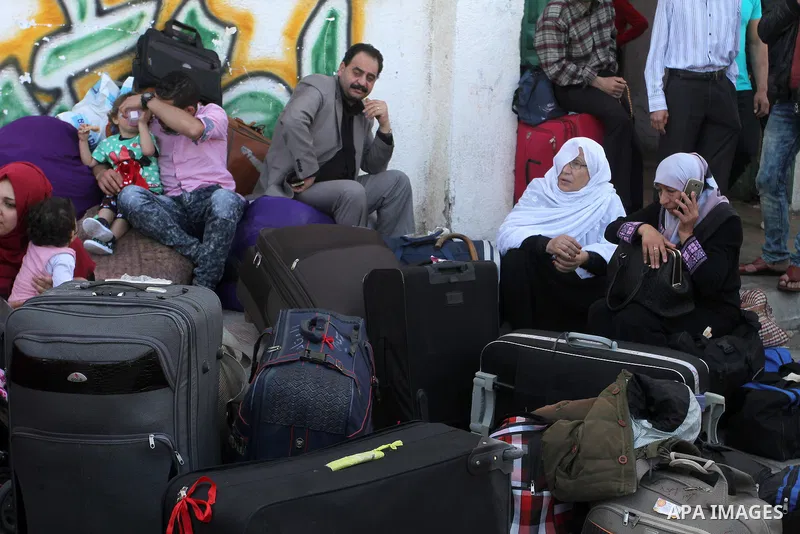 Palestinians wait at the Rafah border crossing with Egypt, in the southern Gaza Strip, after it was opened for two days by Egyptian authorities on May 12, 2016. Israeli Defence Minister Moshe Yaalon announced on May 2, 2...