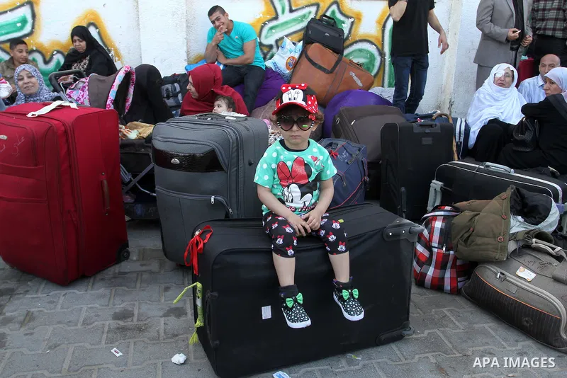 Palestinians wait at the Rafah border crossing with Egypt, in the southern Gaza Strip, after it was opened for two days by Egyptian authorities on May 12, 2016. Israeli Defence Minister Moshe Yaalon announced on May 2, 2...
