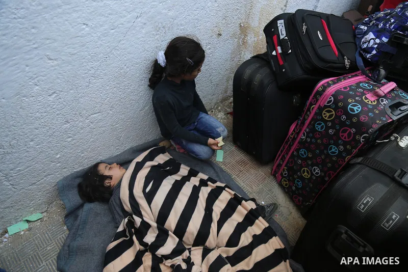 Palestinians wait at the Rafah border crossing with Egypt, in the southern Gaza Strip, after it was opened for two days by Egyptian authorities on May 12, 2016. Israeli Defence Minister Moshe Yaalon announced on May 2, 2...