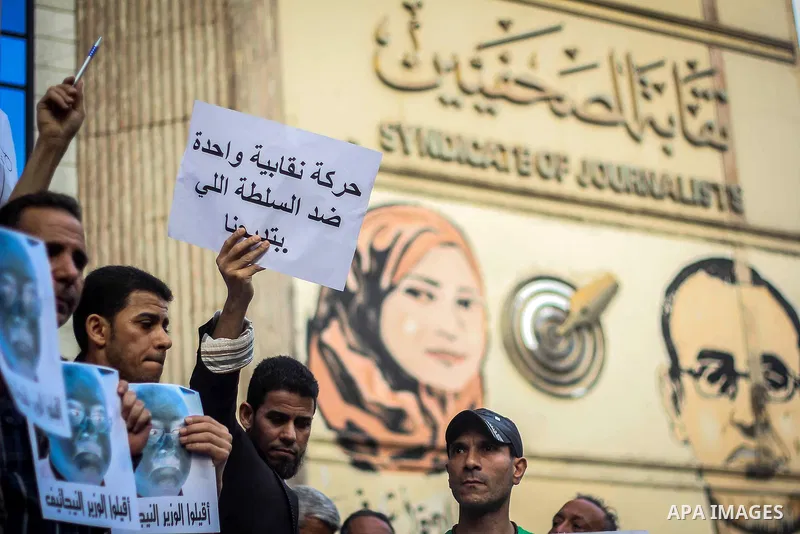 Egyptian Journalists and activists chant slogans and hold banners during a protest in front of the Journalists' Syndicate in Cairo, Egypt, on May 12, 2016. Egypt's journalists' syndicate called for the dismissal of the i...