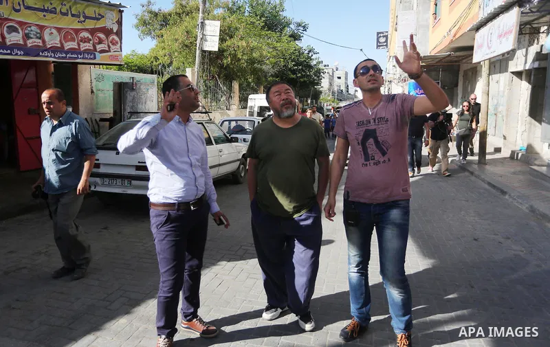 Chinese artist Ai Weiwei and his film crew work on a documentary film on refugees, in Nuseirat refugee camp in the central Gaza Strip on May 12, 2016. Photo by Mohammed Asad