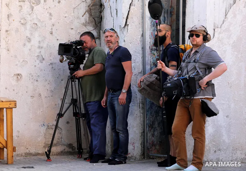 Chinese artist Ai Weiwei and his film crew work on a documentary film on refugees, in Nuseirat refugee camp in the central Gaza Strip on May 12, 2016. Photo by Mohammed Asad