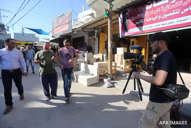 Chinese artist Ai Weiwei and his film crew work on a documentary film on refugees, in Nuseirat refugee camp in the central Gaza Strip on May 12, 2016. Photo by Mohammed Asad
