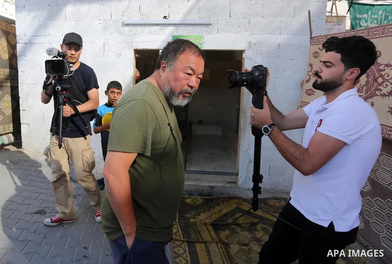 Chinese artist Ai Weiwei and his film crew work on a documentary film on refugees, in Nuseirat refugee camp in the central Gaza Strip on May 12, 2016. Photo by Mohammed Asad